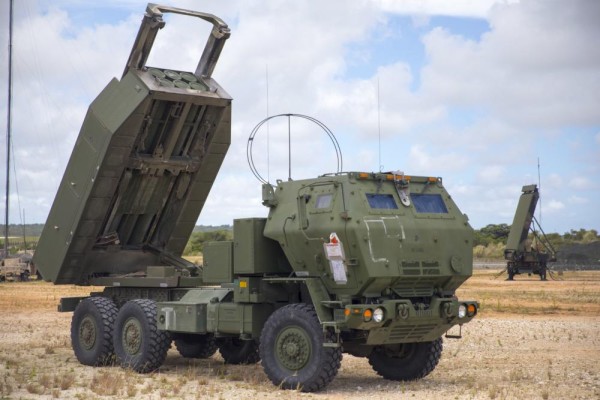 U.S. Marines with 5th Battalion, 11th Marine Regiment set up an M142 High Mobility Artillery Rocket System (HIMARS) in front of an AN/TPS-80 Ground/Air Task Oriented Radar with Marine Air Control Group (MACG) 18 at Andersen Air Force Base, Guam, June 13, 2022, in support of Valiant Shield 2022. (Photo: U.S. Marine Corps by Cpl. Tyler Harmon)  - pics/2022/07/59419_001_t.jpg